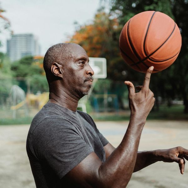 Man holding a difficult balance pose, showing focus and physical control.